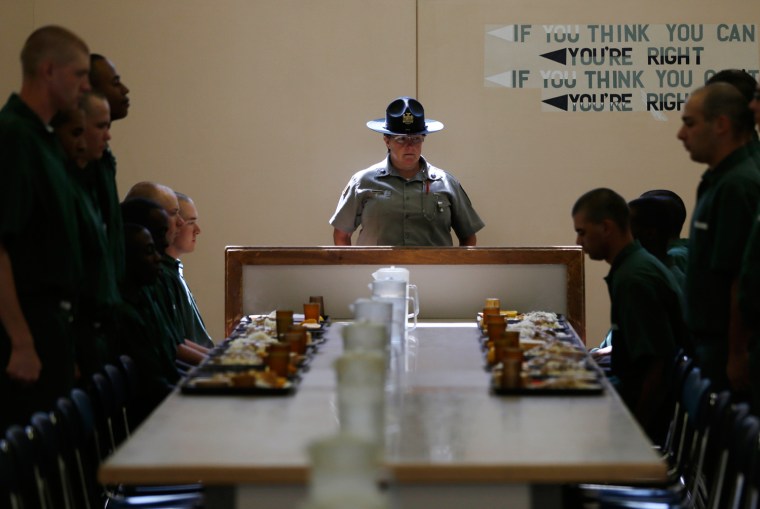 Correctional officer Juleigh Walker watches as inmates sit for lunch at the Moriah Shock Incarceration Correctional Facility, on Aug. 22, in Mineville, N.Y.
