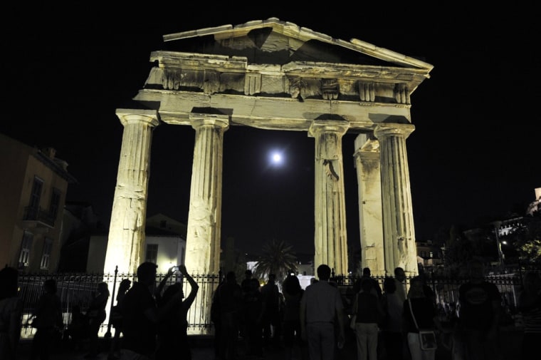 Greeks and tourists gather at the Roman Agora in Athens, which is open all night as part of a full-moon celebration on Aug. 31. A number of archaeological sites and museums around Greece opened at night, with events and concerts celebrating the second full moon of August, known as a