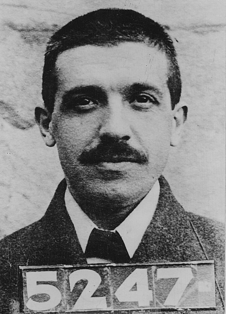 A police mug shot of Italian-born American swindler Charles Ponzi (1882 - 1949) after his arrest for forgery under the name of Charles Bianchi, Montreal, Canada, 1909. Ponzi's name now lives on in the particular fraud known as a ponzi scheme.