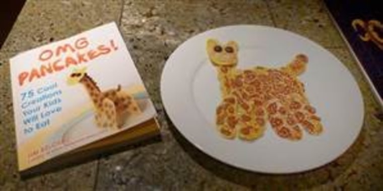 Laura's improvised two-dimensional giraffe pancake is pictured alongside the glorious 3D version on the cover of Jim Belosic's \"OMG Pancakes\" book.