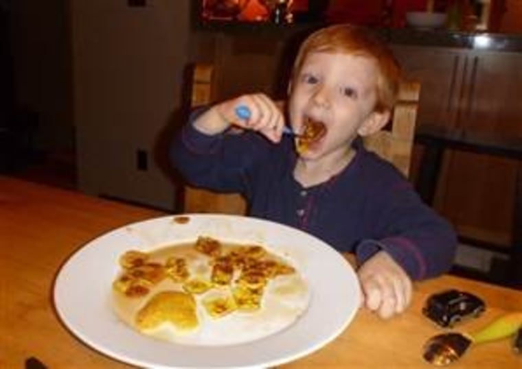 Satisfied customer: Tyler gobbles up his giraffe pancake with gusto.