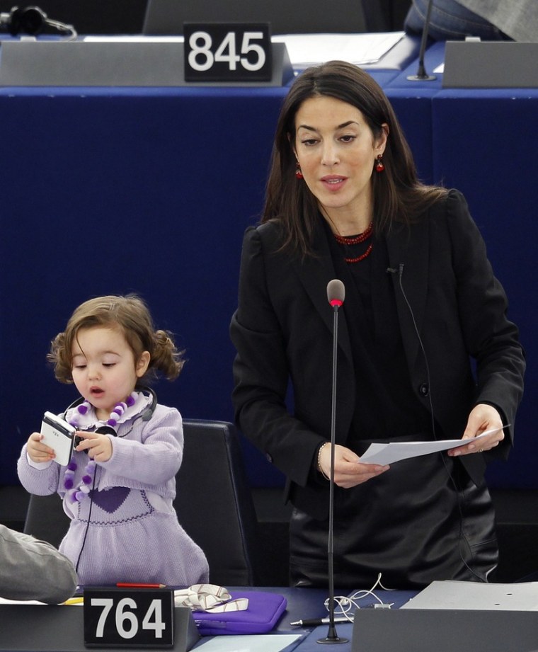 18-month-old Victoria rises with her mother to address the European Parliament after a voting session.