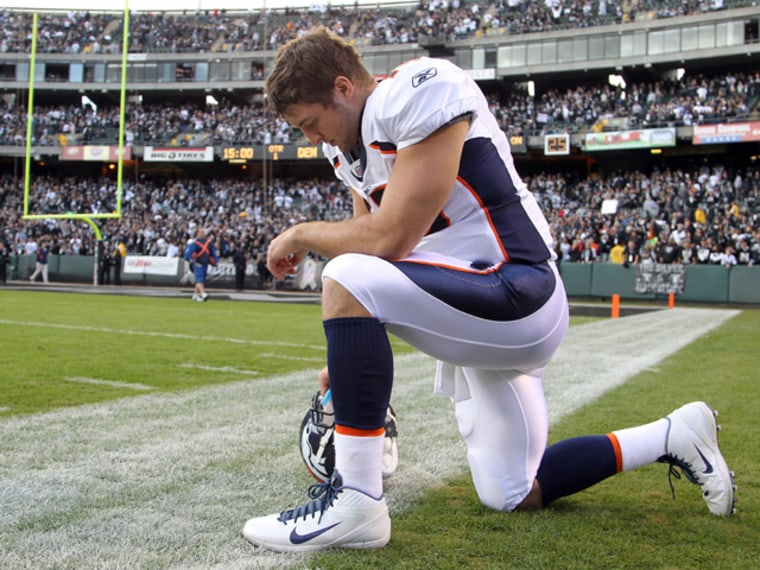 Tim Tebow of the Denver Broncos kneels in prayer before a game.
