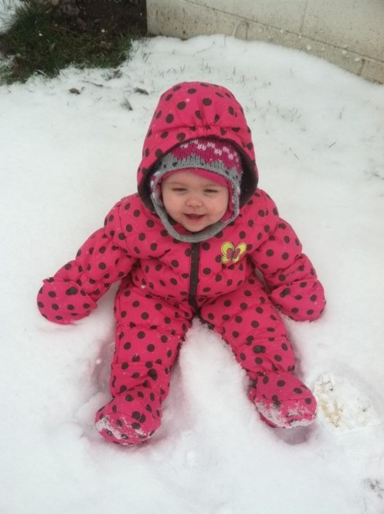 Kinley, 14 months, gets cozy in the snow.