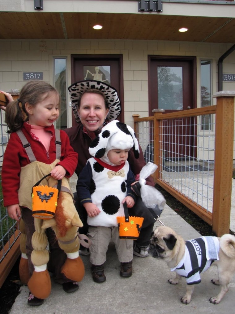Liz Murtaugh Gillespie smiles through her Halloween pain with her daughter Sylvia (horsie on the left), son Tyler (Dalmatian on the right) and pug Pepper (jailbird who clearly wishes she were doing anything but joining the trick-or-treating \"fun\").