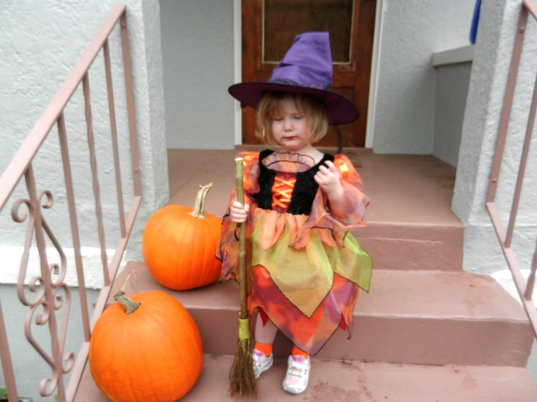 NJ Trott attends her first Halloween party dressed as a little witch.