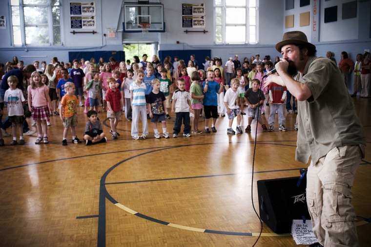 Secret Agent 23 Skidoo entertains a crowd of kids with his brand of \"kid hop.\"