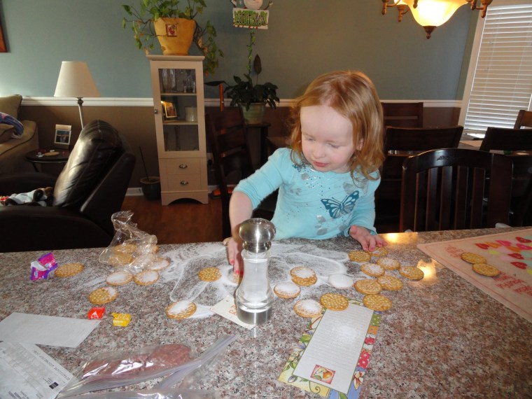 Two-year-old \"making sammies\" -- crackers and salt, anyone?