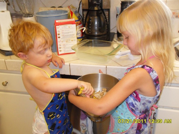 Brianna, 6, and Kaleb, 4, cooking at Nonna's house. Love the aprons!