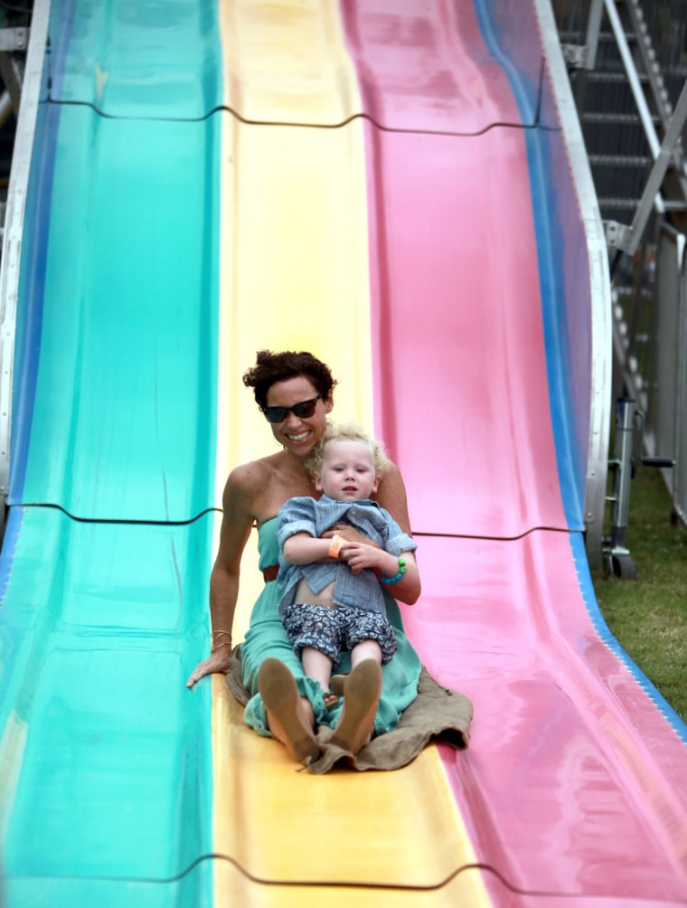 Actress Minnie Driver and her son try out the slide at a charity event in Los Angeles.