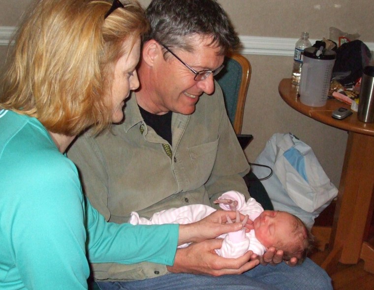 Jodi Pugsley and her husband, Doug, hold their new grandchild, Lauren, born just two hours earlier.