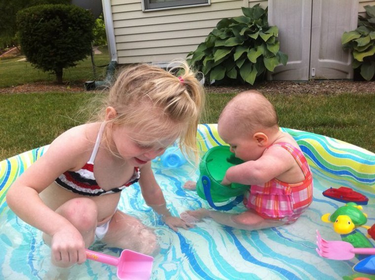 Dodson sisters Jemma and Joss play peacefully in the baby pool.