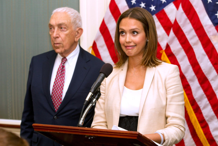Actress Jessica Alba, accompanied by Sen. Frank Lautenberg, D-N.J., reacts when a buzzer calling for a vote goes off during a news conference on Capitol Hill.