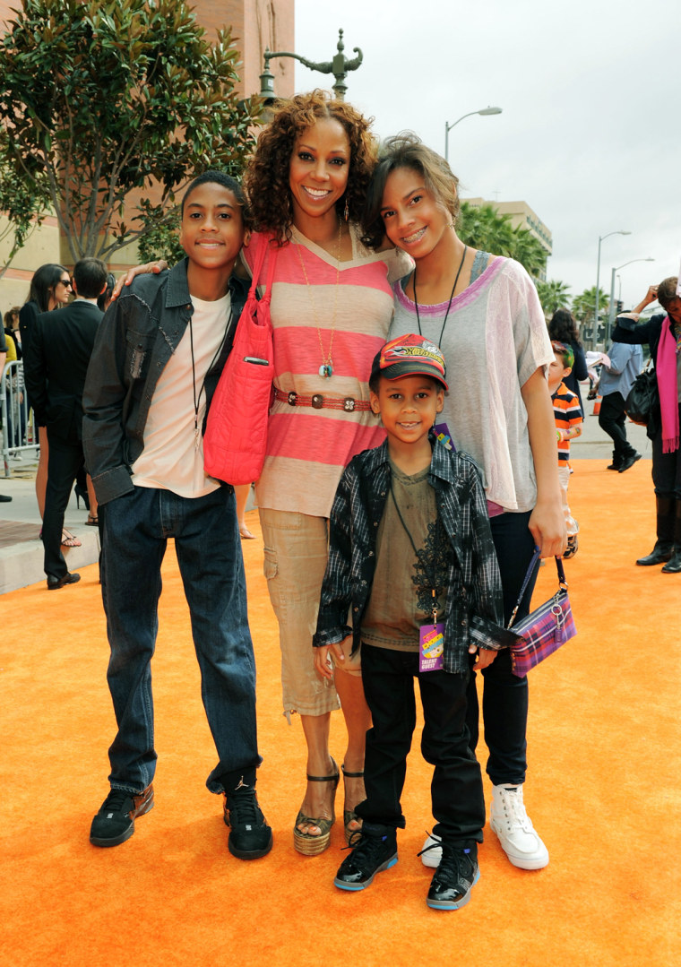Actress Holly Robinson Peete (shown with her kids) has got some serious diaper changing skills.