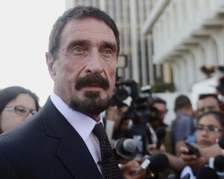 U.S. anti-virus software pioneer John McAfee listens to questions from a journalist in front of the Supreme Court in Guatemala City on Dec. 4, 2012.