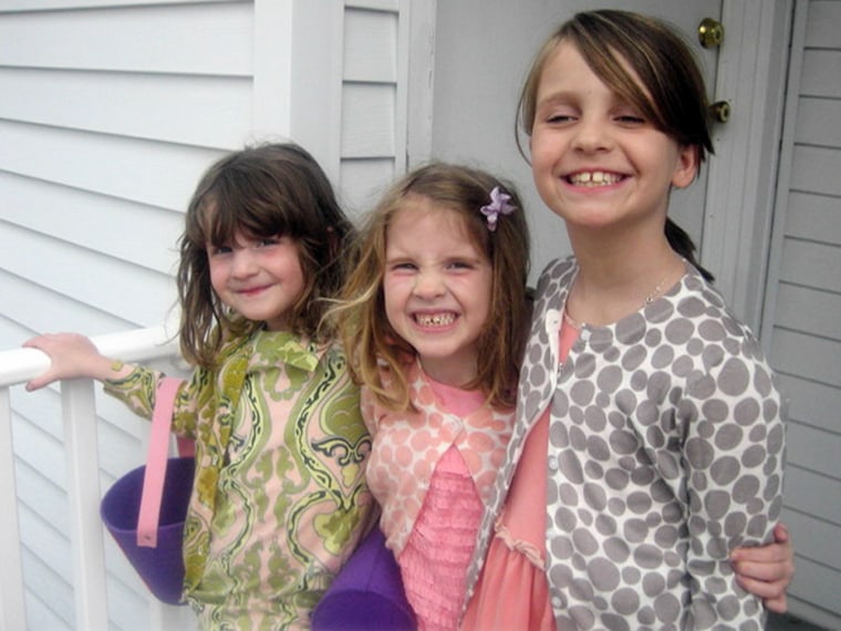 Madonna Badger claims she has had visions of her three young daughters lost in the fire, twins Sarah and Grace, 7 (left), and Lily, 9. A fund has been set up in their name to support arts education in public schools.