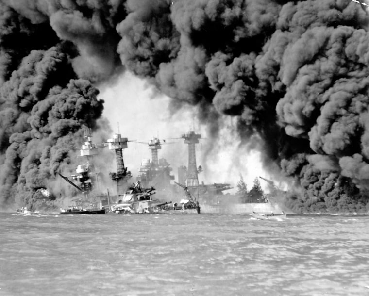 Smoke pours from wrecked American warships after the Japanese surprise attack on Pearl Harbor on Dec. 7, 1941.