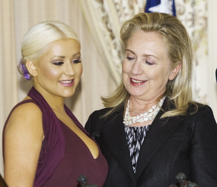 Christina Aguilera, left, and Secretary of State Hillary Clinton pose at the State Department in Washington on Oct. 3.
