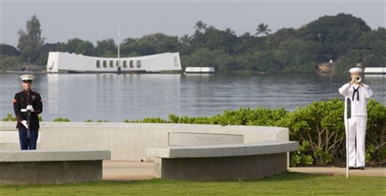 Taps are played during a ceremony commemorating the Japanese attack on Pearl Harbor on Friday, at Pearl Harbor, Hawaii.