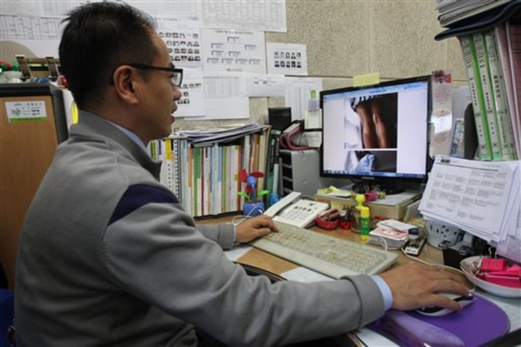 In this Nov. 20, 2012 photo, Moon Tae-hwa, a devout Christian and family counselor, uses a desktop computer to hunt down online pornography at his off...