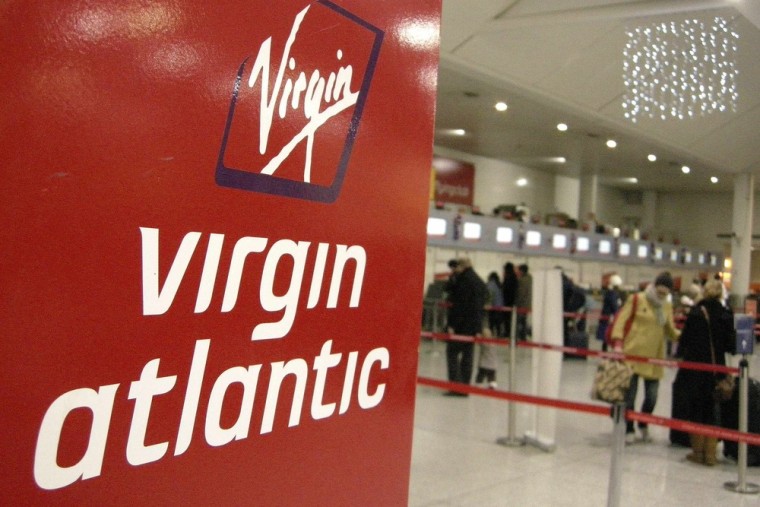 A Virgin Atlantic logo is seen at check-in desks at Gatwick airport, in southern England in this December 21, 2007 file photo. Delta says it bought Si...
