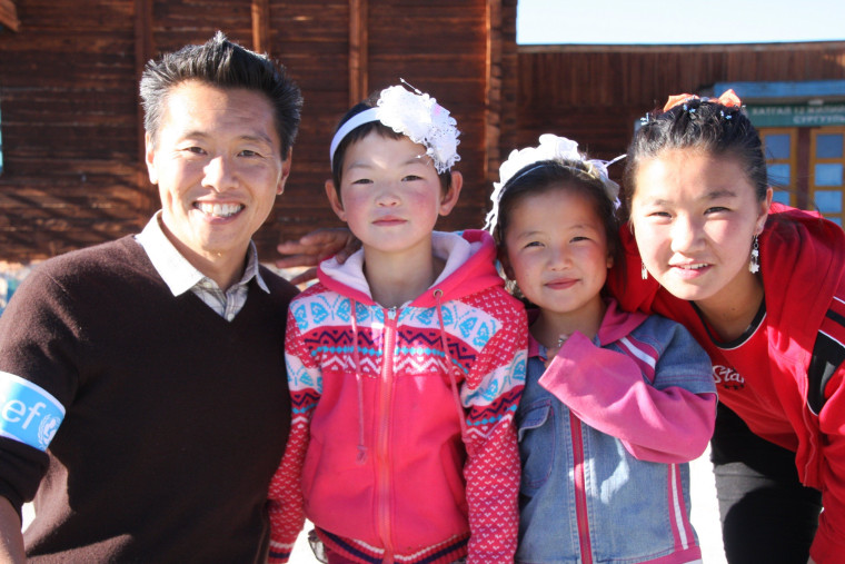 UNICEF Ambassador Vern Yip is all smiles with students at a dormitory school in Khuvsghul province, Mongolia.