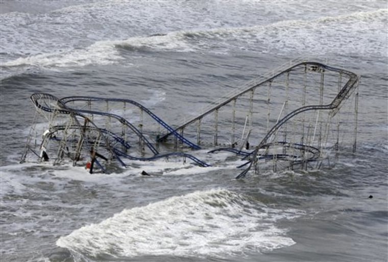 In this Wednesday, Oct. 31, 2012 file photo, waves wash over a roller coaster from a Seaside Heights, N.J. amusement park that fell in the Atlantic