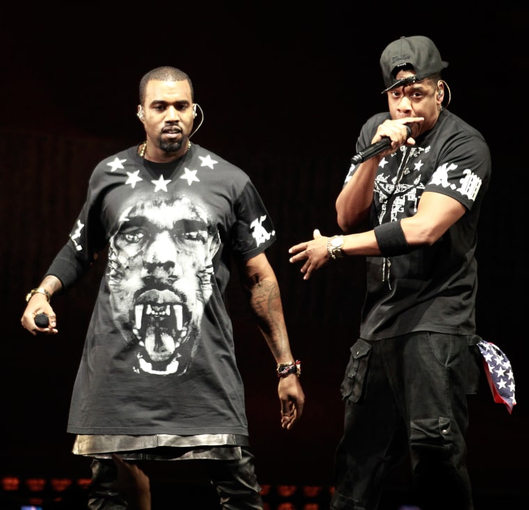 Old territory: Kanye West, in a leather skirt, performs with Jay Z during the