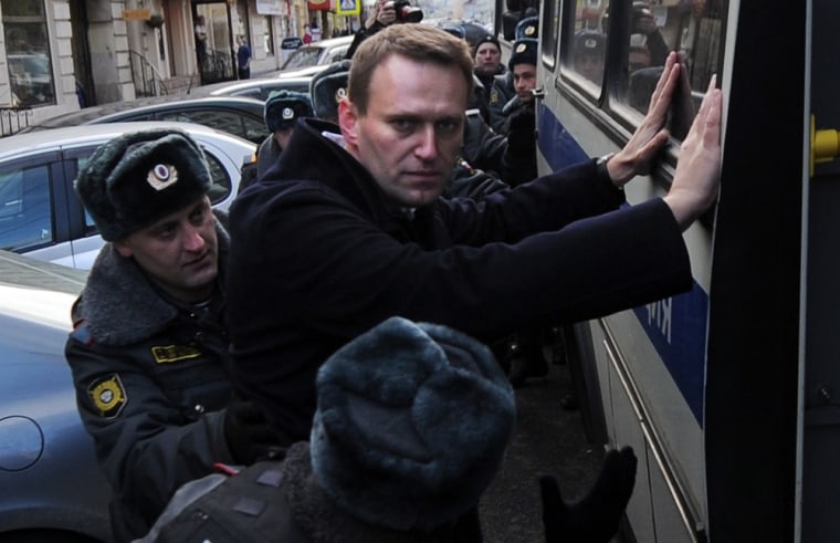 Russian opposition activist and blogger Alexei Navalny (center) is detained by the police on Oct. 27 during a protest over a wave of arrests and allegations that an opposition leader was tortured.