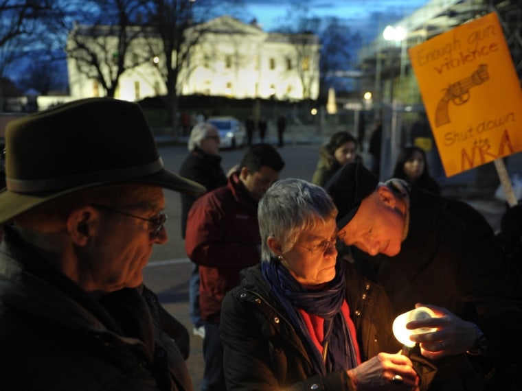 Gun control supporters take part in a candlelight vigil at Lafayette Square across from the White House on December 15, 2012 in Washington. Twenty-sev...