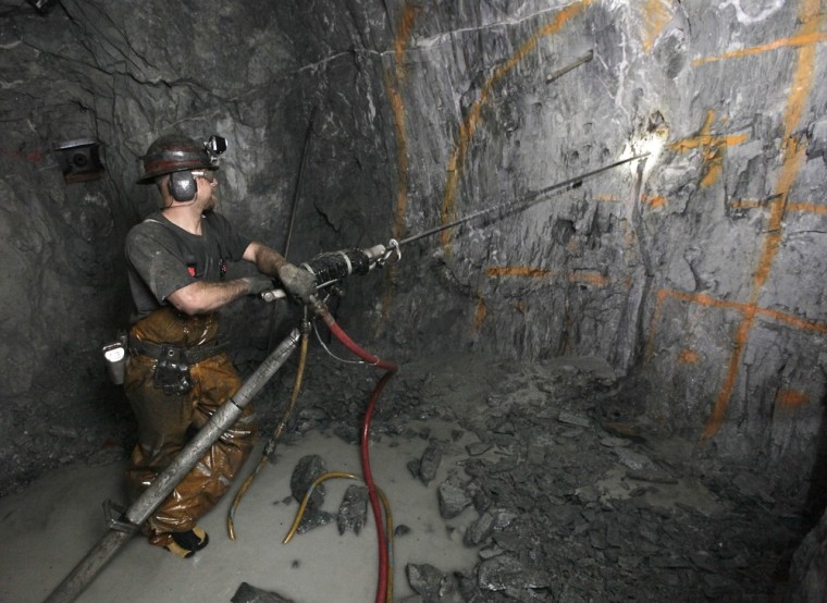 Miner Keith Emerald uses a pneumatic drill to drill holes that will be packed with explosives to blast into the sold rock wall at the Sutter Gold Mining Co.'s mines near Sutter Creek, Calif.