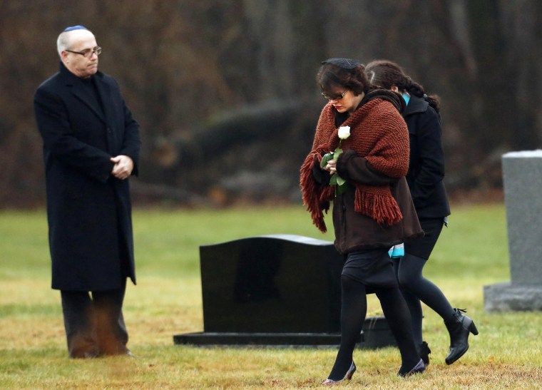 Veronique Pozner, front, the mother of Sandy Hook Elementary School shooting victim Noah Pozner, arrives for his burial at the B'nai Israel Cemetery in Monroe, Conn., on Monday, Dec. 17. Two funerals on Monday ushered in what will be a week of memorial services and burials for the 20 children and six adults killed at the school in Newtown, Conn.
