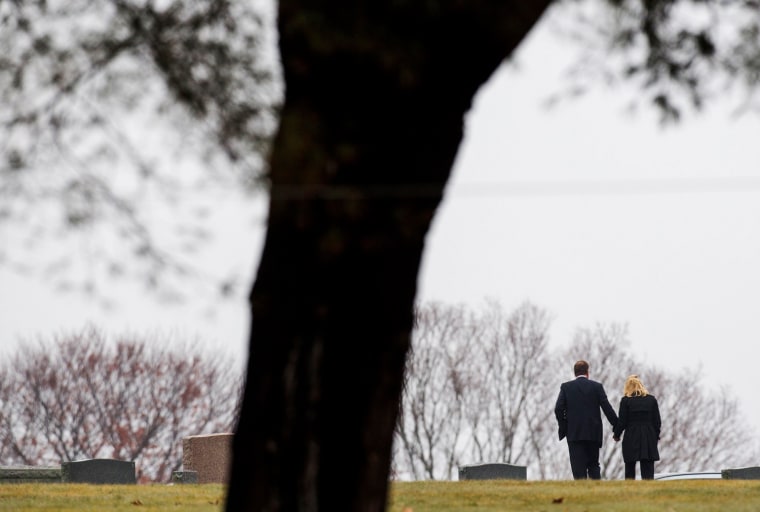 A couple walks away away from the burial service for 6-year-old Jack Pinto at the Newtown Village Cemetery in Newtown, Conn., on Dec. 17. Pinto was one of 20 schoolchildren killed in the Dec. 14 shootings at Sandy Hook Elementary School.
