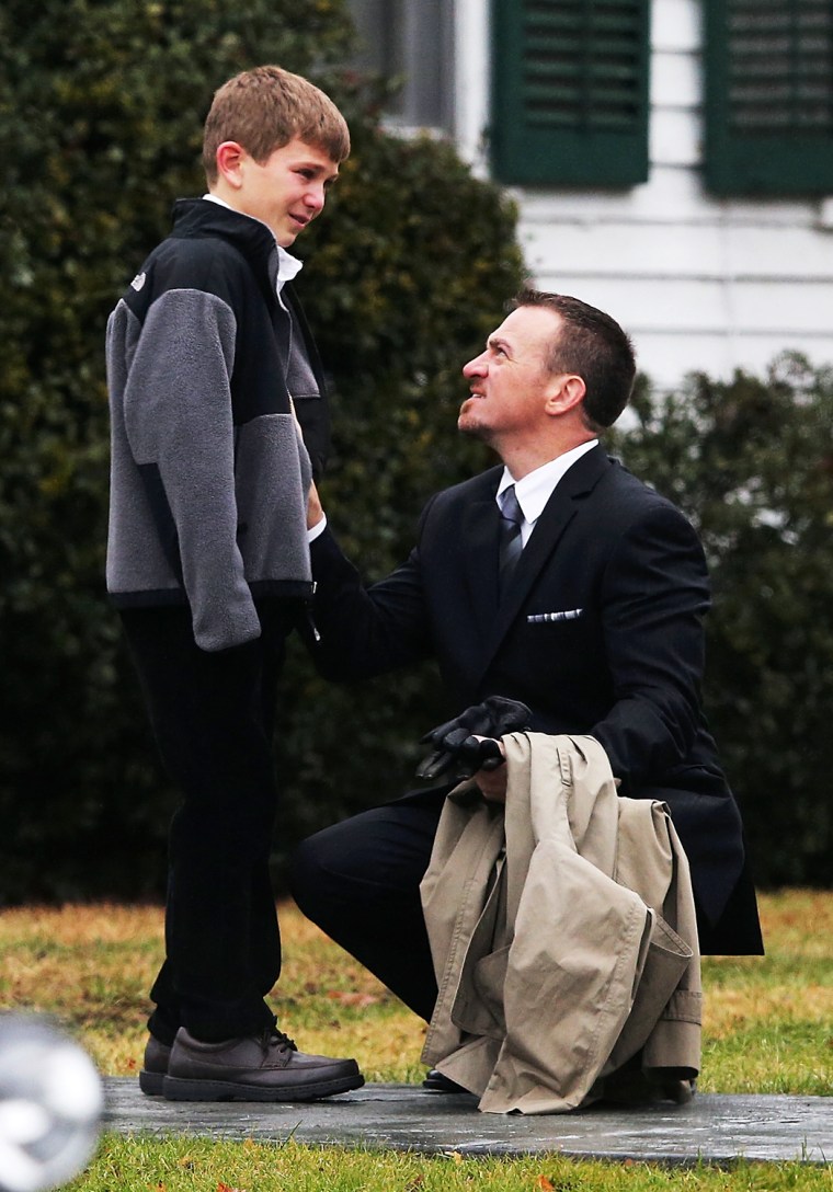 A man comforts a boy outside Honan Funeral Home before the funeral for 6-year-old Jack Pinto on Dec. 17 in Newtown, Conn.