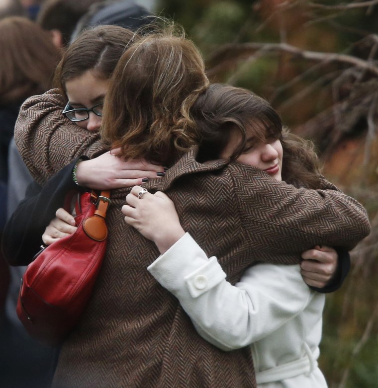 Mourners hug before the funeral service for 6-year-old Noah Pozner, on Dec. 17 in Fairfield, Conn.