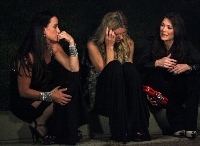 Kyle Richards, left, and Lisa Vanderpump, right, console Brandi Glanville during Kyle's dinner party.
