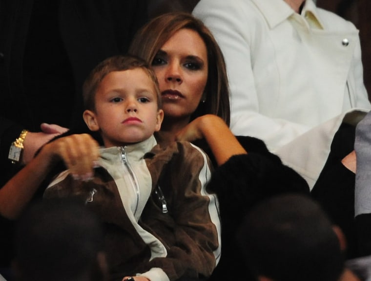 Runs in the family: Victoria Beckham embraces son Romeo on March 26, 2008 in Paris, France.