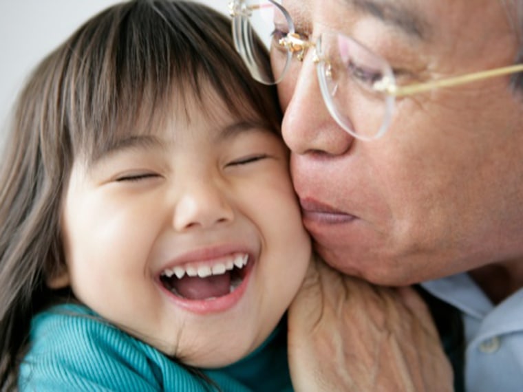 Grandfather kissing granddaughter, close-up