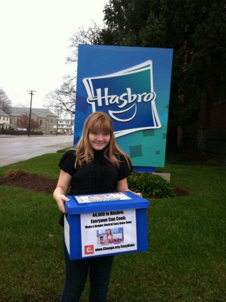 McKenna Pope prepares to enter Hasbro headquarters holding a box containing some of the 44,000 electronically signed petitions.