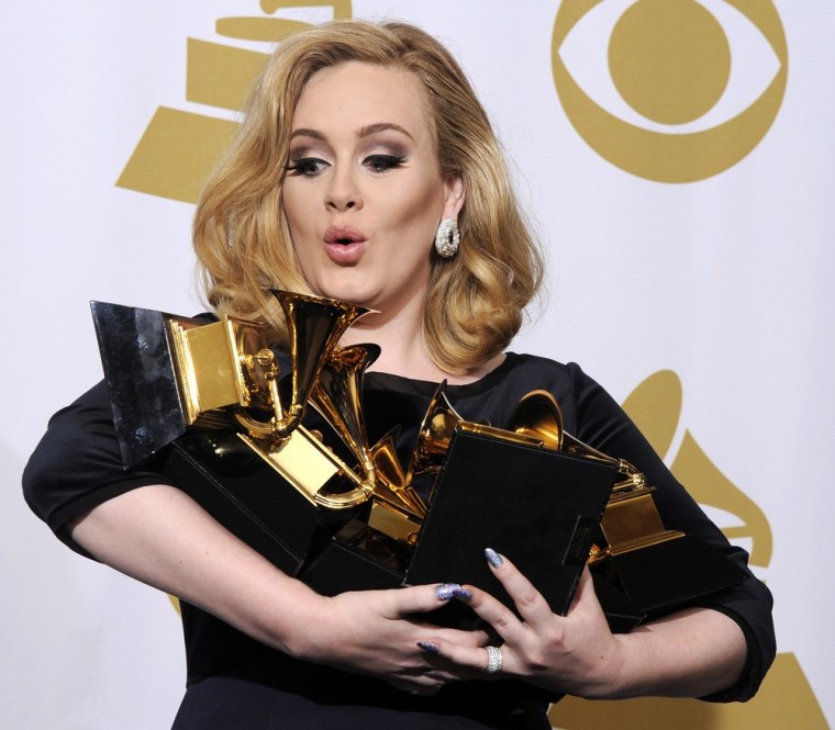 British singer Adele holds her six Grammy Awards in Los Angeles in February.