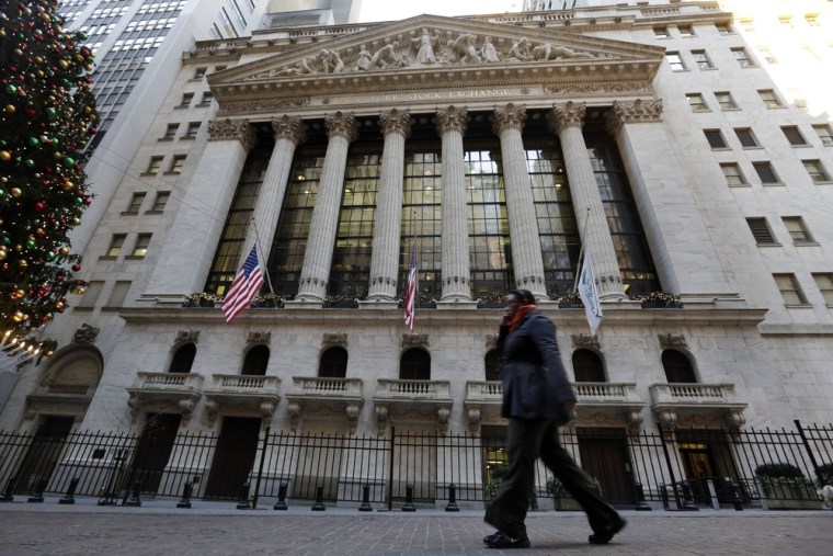 A woman walks by the New York Stock Exchange Thursday, Dec. 20, 2012. The NYSE will be bought by IntercontinentalExchange in a $8.2 billion dollar dea...