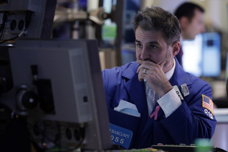 Specialist Anthony Rinaldi works on the floor of the New York Stock Exchange Friday, Dec. 21, 2012. Stocks were sharply lower as a setback in talks to...