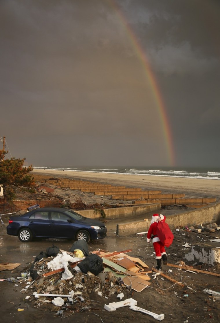 A rainbow appears as Michael Sciaraffo leaves the home of Ella Sampol in Belle Harbor, Queens on Dec. 18, 2012.