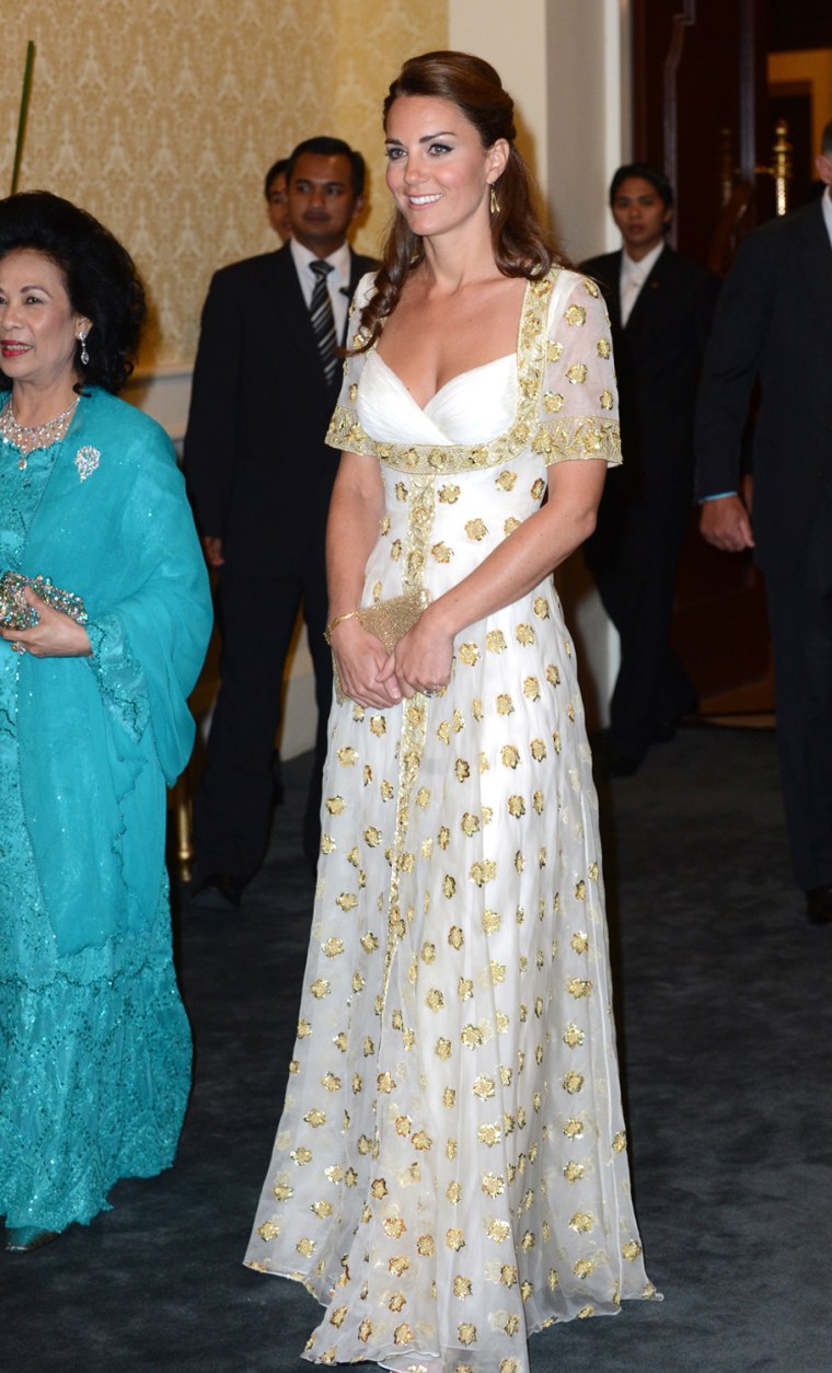 The Duchess attends an official dinner hosted by Malaysia's Head of State Sultan Abdul Halim Mu'adzam Shah of Kedah on Sept. 13. The gold-and-white gown was designed by Alexander McQueen and has the national flower of Malaysia, the hibiscus, embroidered on it.
