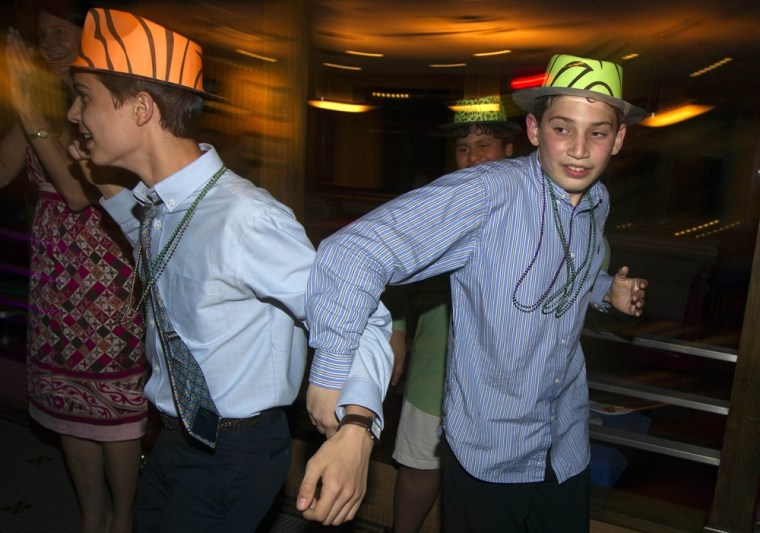Matthew, right, plays with a friend during his bar mitzvah in Melville, New York on June 16, 2012.