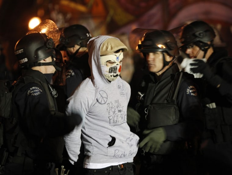 Los Angeles Police Department officers arrest an Occupy LA protester at the encampment at City Hall on Nov. 30, 2011.