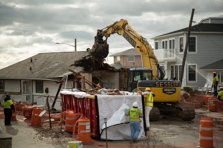 The U.S. Army Corps of Engineers oversees the demolition on Saturday of a home in Breezy Point, N.Y. The house floated off its foundation during Superstorm Sandy and came to rest in the middle of Beach 215th Street.