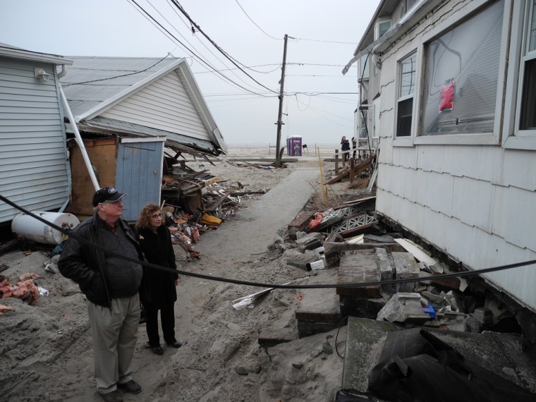 Madeline DiLorenzo-Coscia, 63, and her husband, Jerome Hoffman, 62, look at their 'little frame shack' in Breezy Point on Dec. 8.