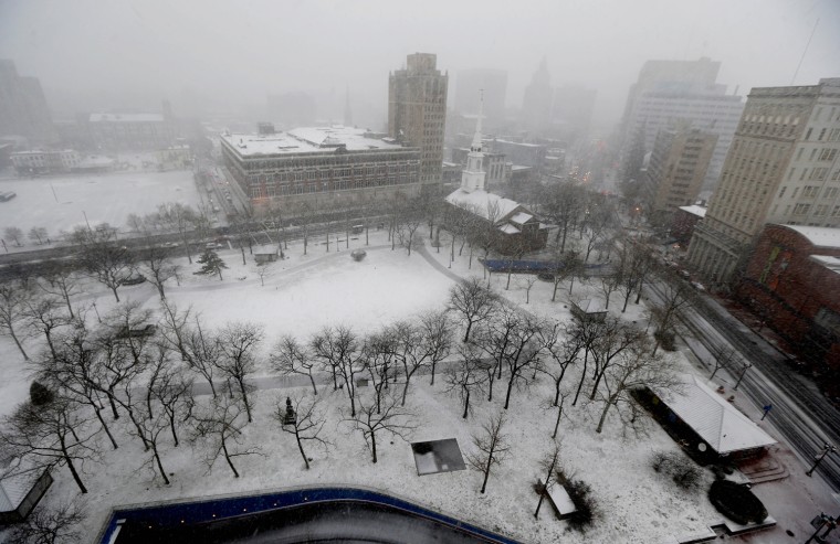 Snow falls over Military Park in downtown Newark, N.J., on Dec. 26. The National Weather Service forecast predicts sustained winds of 15 to 20 mph along the coast in the afternoon, with gusts up to 40 mph.