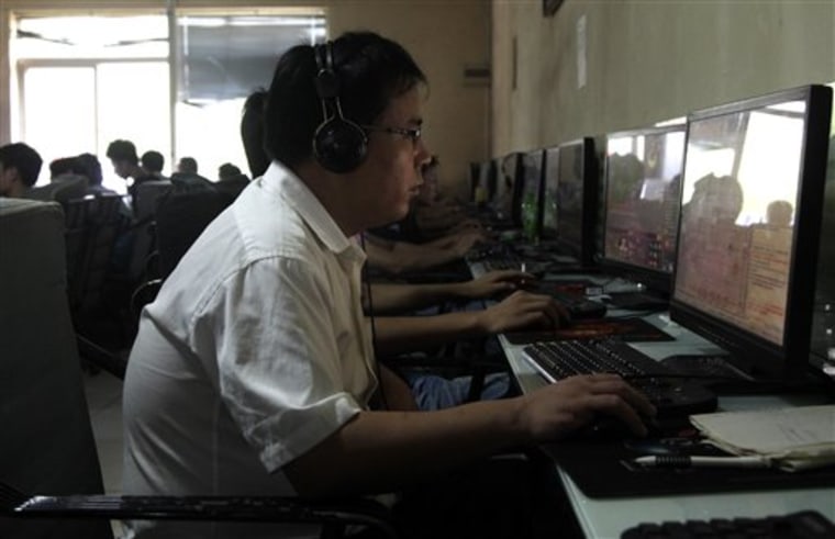 In this July 14, 2010 file photo, a Chinese man uses a computer at an Internet cafe in Beijing. China's new communist leaders are increasing al...